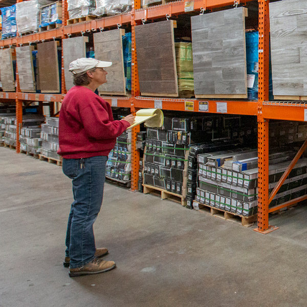 Contractor standing in front of pallettes in a Home Depot aisle